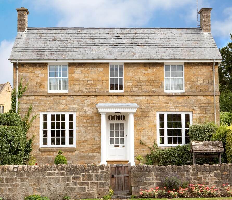 external shot of residential house with white sash windows and white door