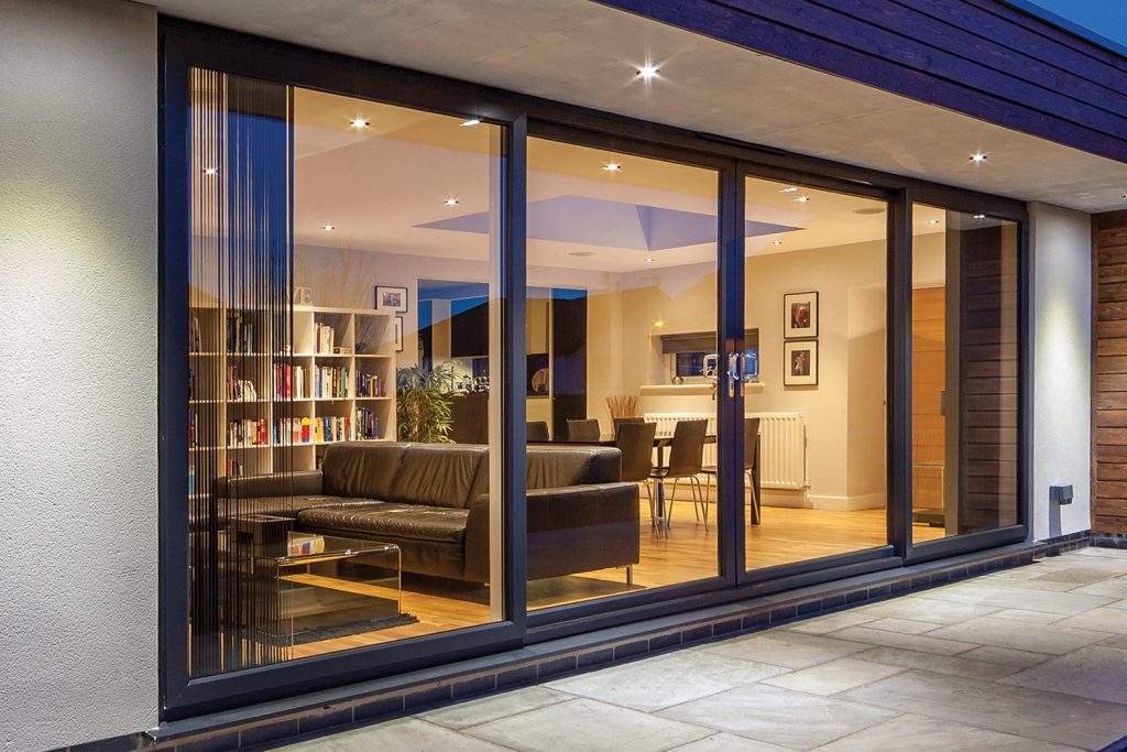 Inline sliding patio door in black at night time