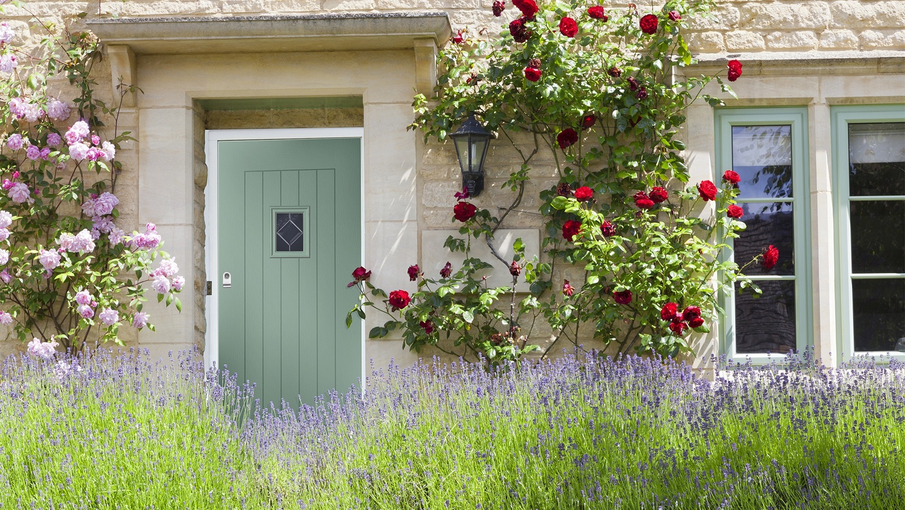 Cotswold green Composite door and windows on a residential home